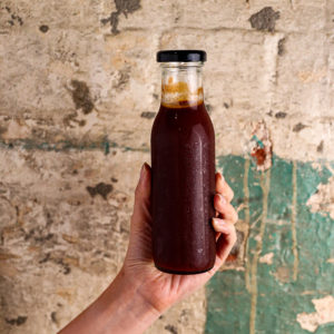 Frankie's Smokehouse BBQ Sauce in glass bottle being help